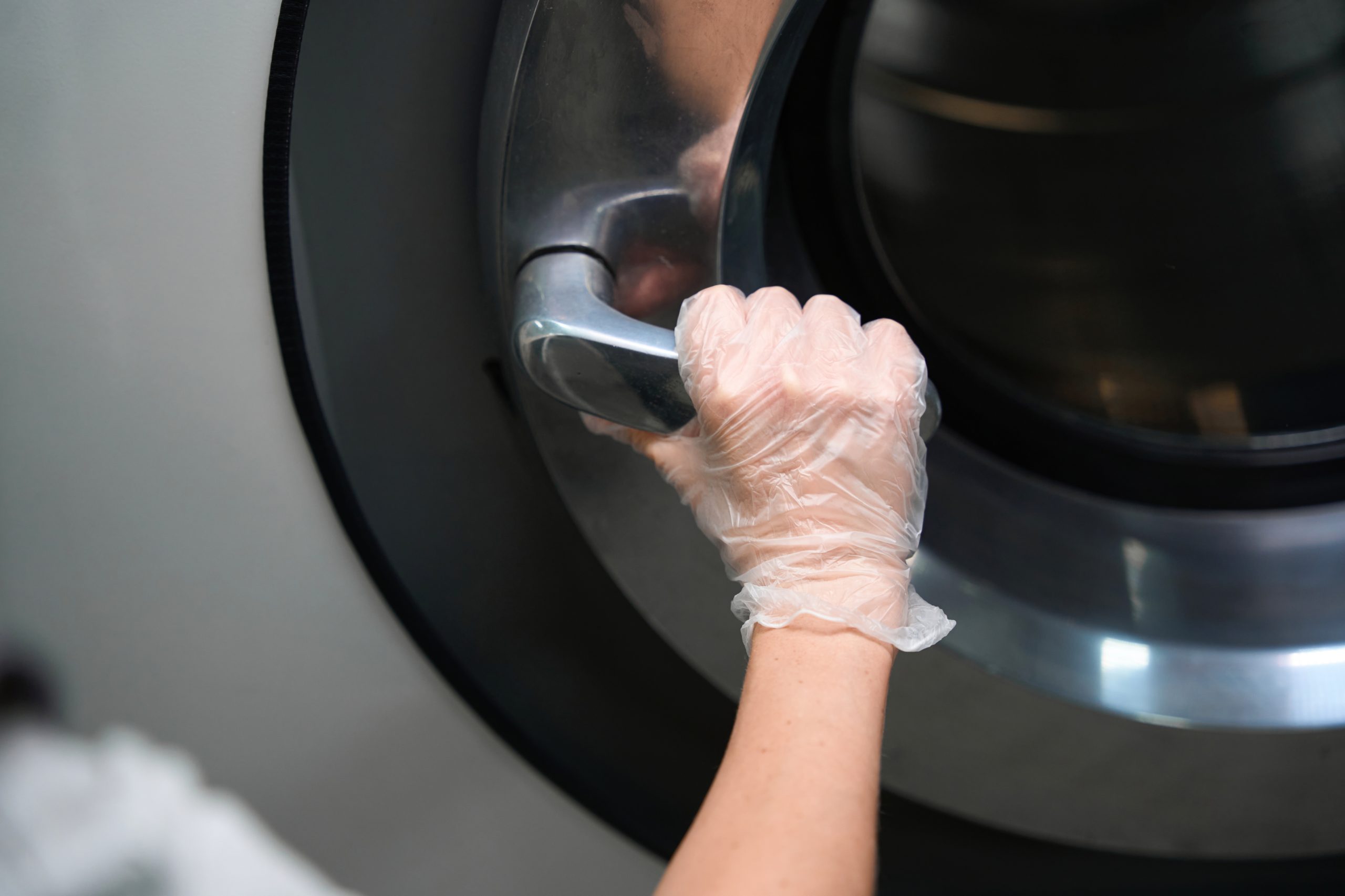 Technician opening a dryer drum to clean the vent